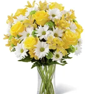 Vase with yellow roses, yellow alstroemeria, white chrysanthemums, ferns, and a clear vase