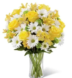 Vase with yellow roses, yellow alstroemeria, white chrysanthemums, ferns, and a clear vase