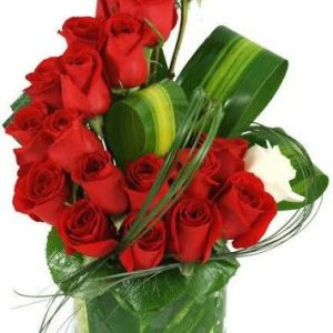 Elevate your expression of love with two dozen red roses arrangement, beautifully complemented by greenery and presented in a vase. A timeless gift of romance