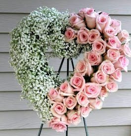 Order same-day funeral flowers delivery in Nairobi today, a Special Heart Wreath Arrangement with pink roses and baby's breath. Order now