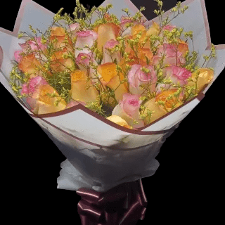 Present love with our Lovely Present Bouquet featuring golden roses, pink blooms, and fillers. A charming arrangement conveying affection & timeless elegance