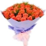 Orange Roses Bouquet wrapped in elegant paper, fresh flowers hand-tied by a Nairobi florist with same-day delivery available.