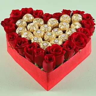 Order the Amour heart box arrangement of 20 pieces of Ferrero chocolate and red roses. Share love and romance with those whom you care more in life today
