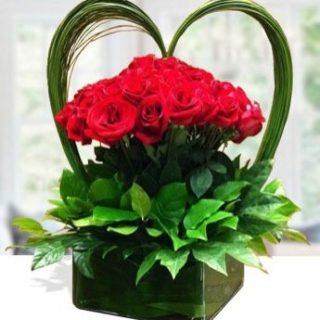 Capture the perfect love bouquet with our exquisite red roses and lush greenery, elegantly presented in a stylish flower vase. A timeless expression of love