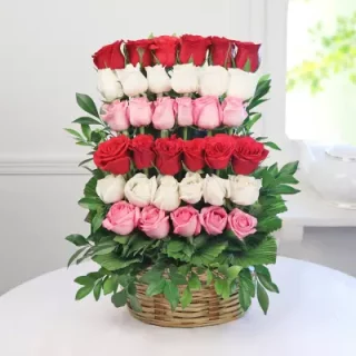 Shop same-day fresh flowers with a Ladder Love Basket arrangement of 36 stems of red, pink, and white roses and  ruscus perfectly arranged in a basket