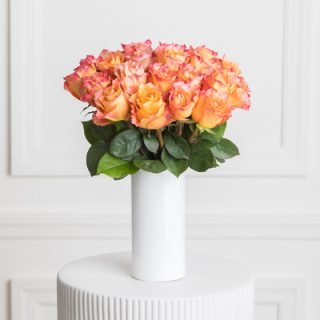 Elevate your dedication night with the warmth of orange roses in our exquisite flower vase arrangement. A symbol of dedication and vibrant beauty