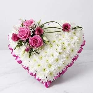 Heart shape Tribute wreath with white chrysanthemums, pink roses, baby's breath, and greenery