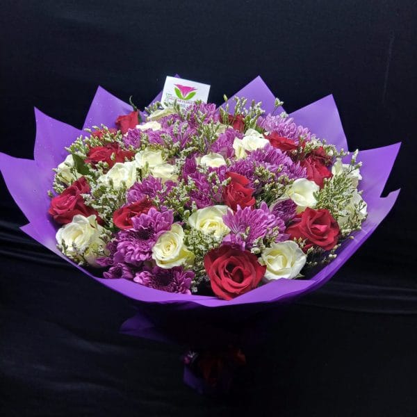 The Lovely Present Bouquet showcases chrysanthemums, red and white roses, and baby’s breath, creating a timeless display of love and affection. Same-day flower delivery in Nairobi!