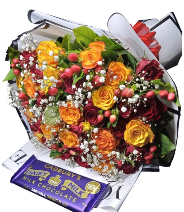 Share joy with the Whimsical Wonder bouquet featuring yellow and red roses, hypericum, baby's breath, and Cadbury chocolate for a sweet touch.