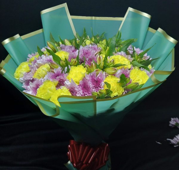 A vibrant bouquet of alstroemeria, yellow chrysanthemums, and purple chrysanthemums, arranged in a lively and cheerful display.