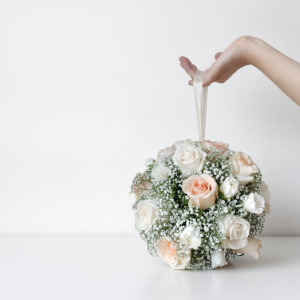 Pomander bridal bouquet with white and blush roses and baby's breath