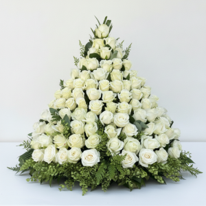 Triangular white rose pedestal with lush greenery for weddings and events in Nairobi Kenya.