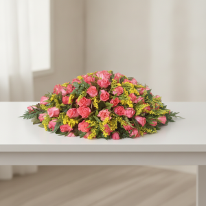 Pink table flower arrangement with roses, yellow filler flowers and greenery for events in Nairobi Kenya.