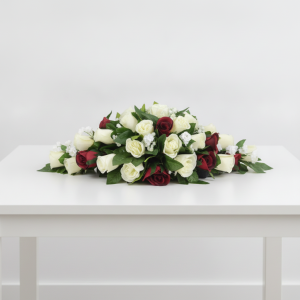 Top table flower arrangement with red and white roses, baby’s breath and greenery for a wedding in Nairobi Kenya.